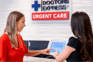 receptionist at a healthcare facility assisting a patient checking in